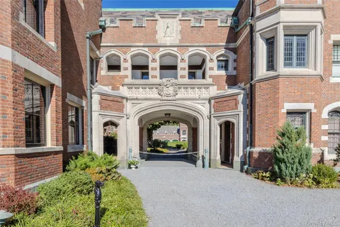 a view of a brick house with large windows