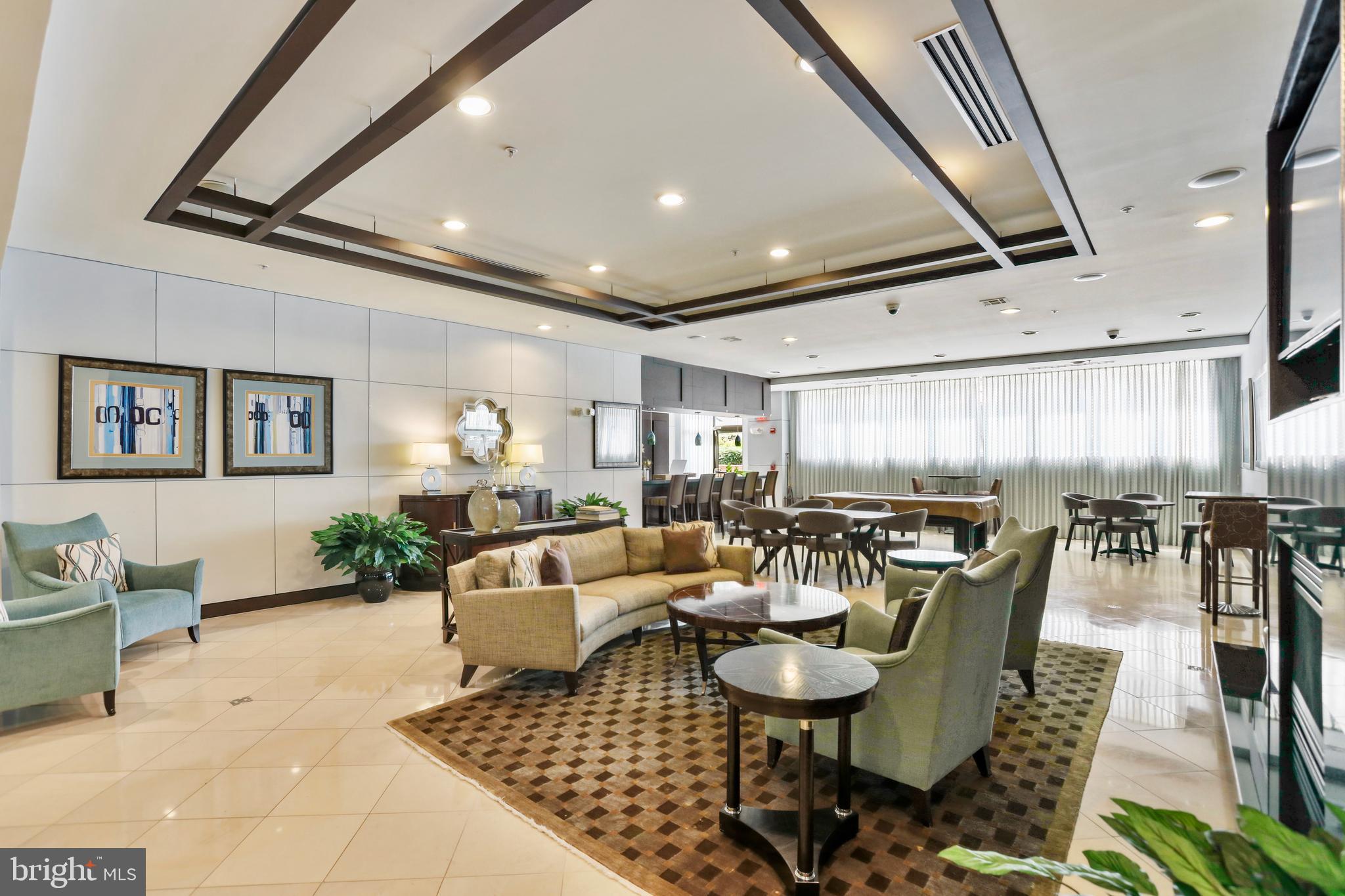 12001 Market Street, Unit T35 Reston, VA 20190 - Photo 16 of 23 a living room with lots of furniture and a rug