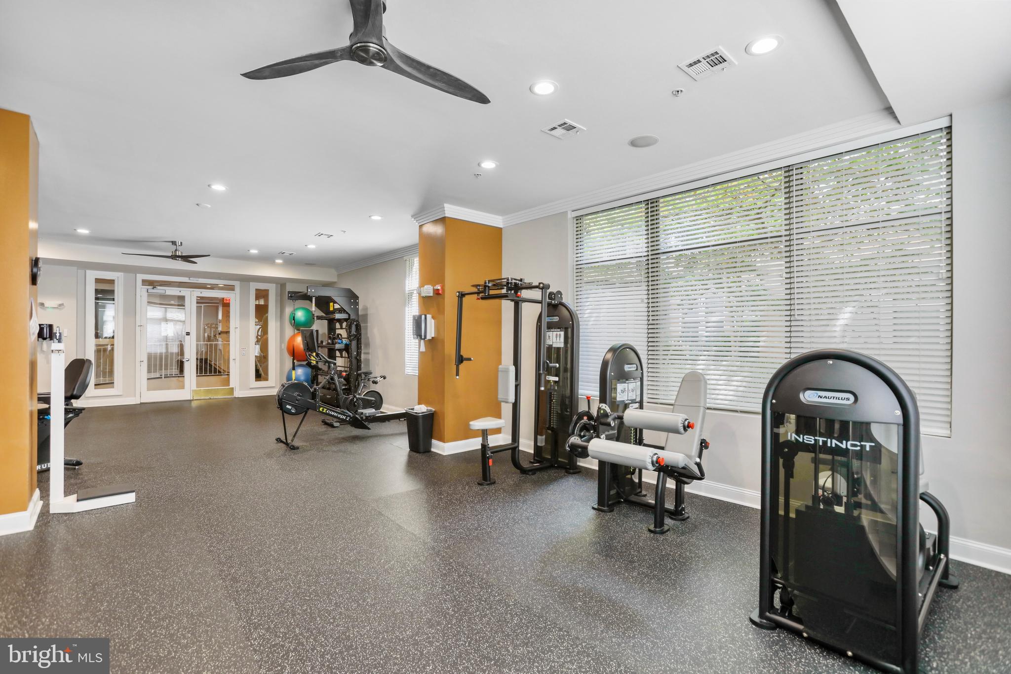 12001 Market Street, Unit T35 Reston, VA 20190 - Photo 19 of 23 a living room with furniture gym equipment and a large window