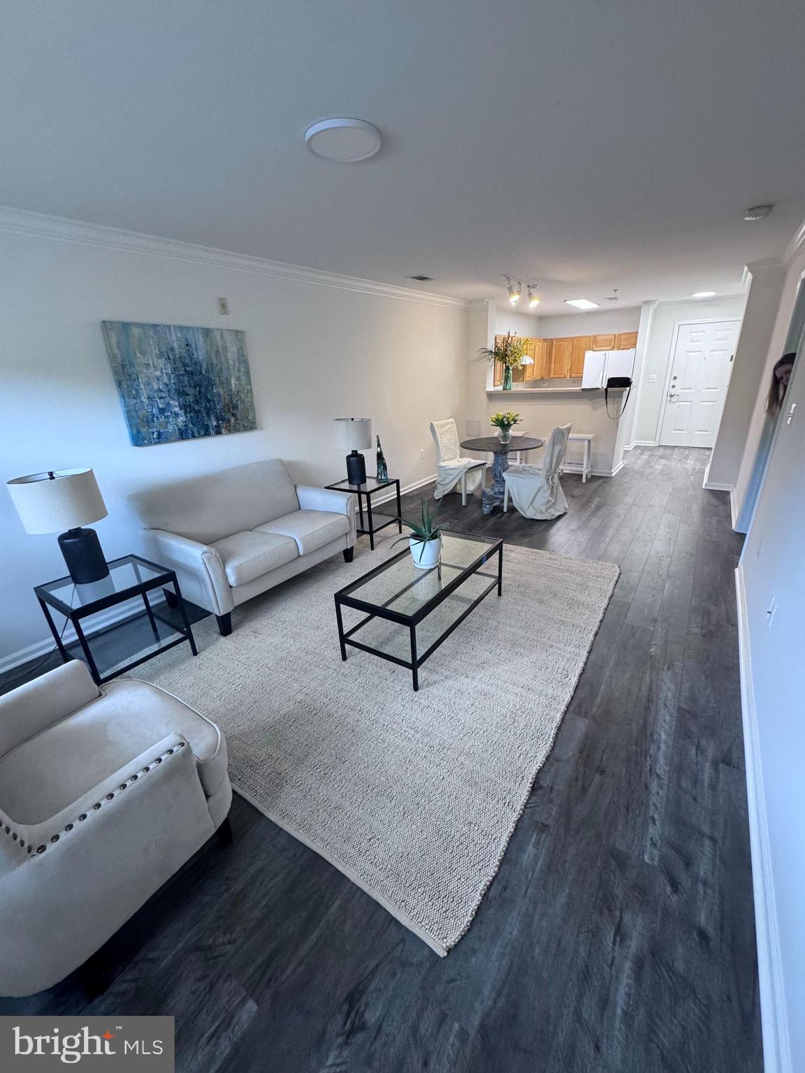 12001 Market Street, Unit T35 Reston, VA 20190 - Photo 6 of 23 a living room with furniture and wooden floor