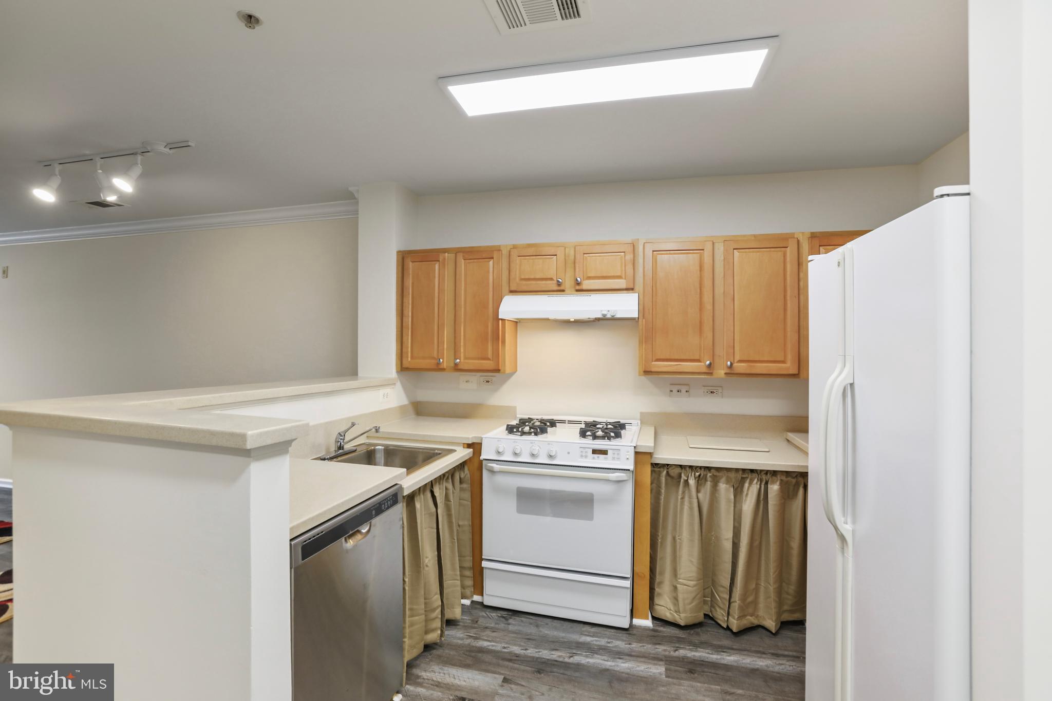 12001 Market Street, Unit T35 Reston, VA 20190 - Photo 8 of 23 a kitchen with a stove and a refrigerator