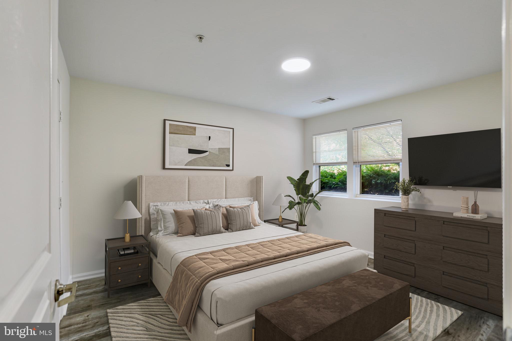 12001 Market Street, Unit T35 Reston, VA 20190 - Photo 10 of 23 a bedroom with a bed and a flat screen tv