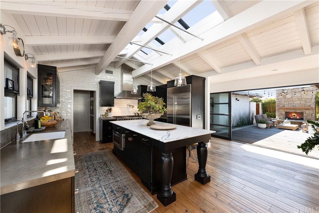 32561 Balearic Dana Point, CA 92629 - Photo 17 of 41 View of kitchen with overhead skylights and sliding doors to courtyard with fireplace. Tons of room for entertaining.