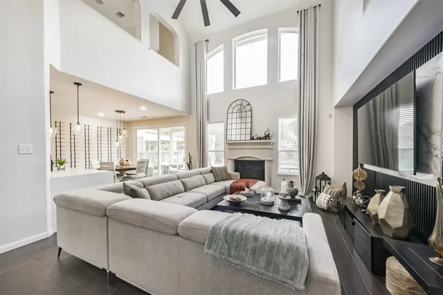 a living room with furniture fireplace and a large window