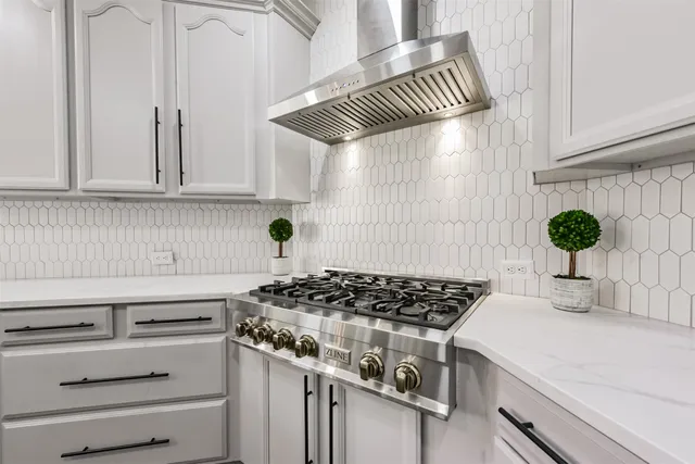 a view of a patio with table and chairs with wooden floor and fence