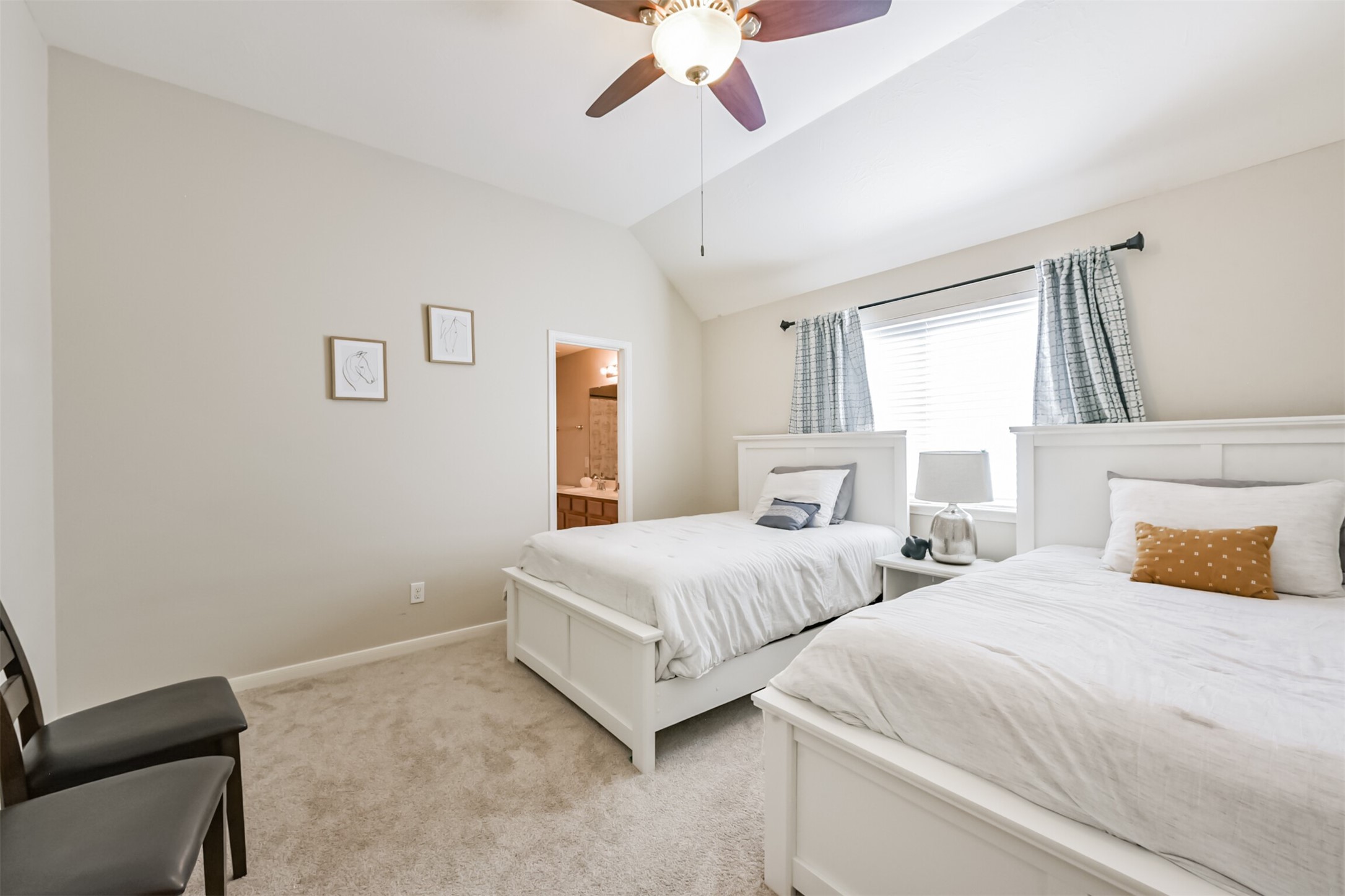 6806 Russelfield Lane Houston, TX 77049 - Photo 38 of 46 a bedroom with two beds and a chandelier