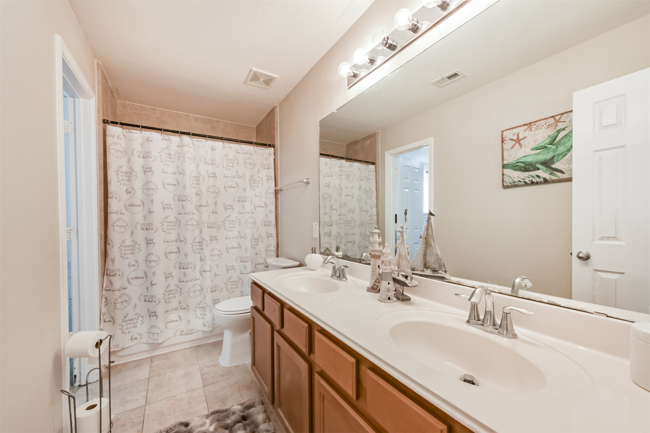 6806 Russelfield Lane Houston, TX 77049 - Photo 40 of 46 a bathroom with a double vanity sink mirror and shower