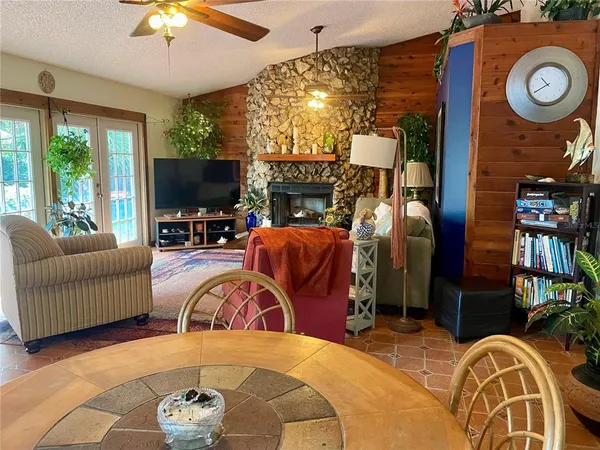 a living room with furniture a fireplace and a flat screen tv