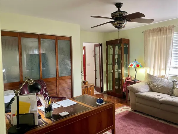 a living room with furniture and large windows