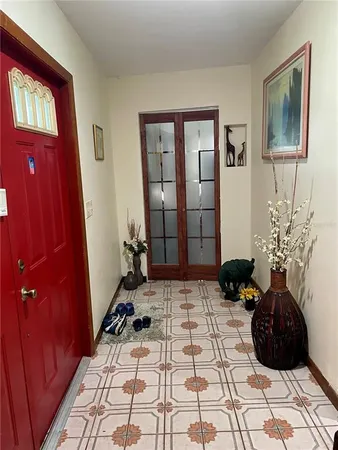 a view of a entryway door with a rug