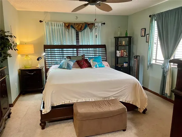 a bed sitting in a bedroom next to a window