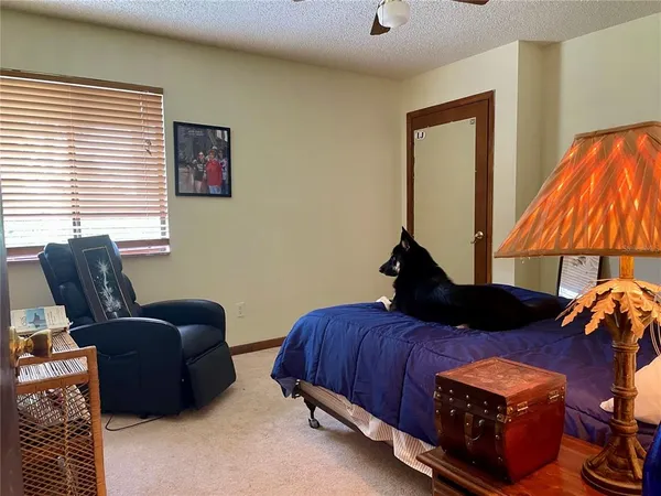 a bedroom with two beds and a lamp