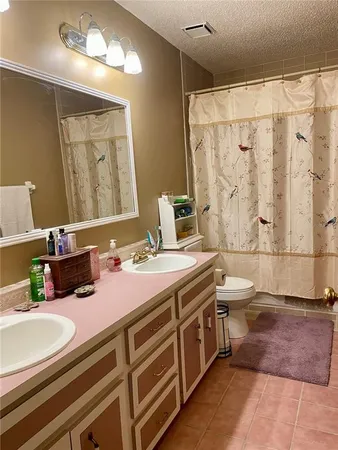 a bathroom with a double vanity sink mirror and bathtub