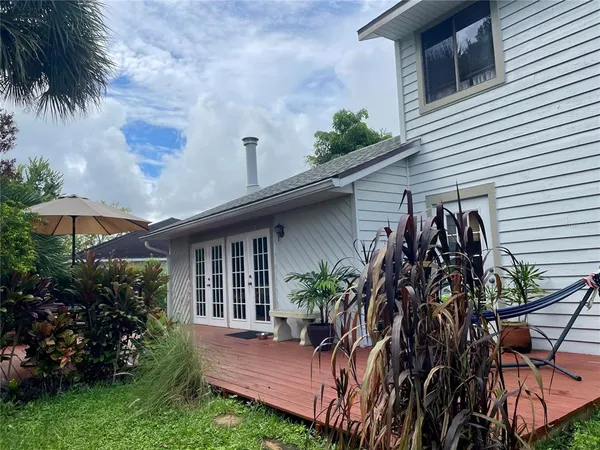 a view front of house with a yard and potted plants