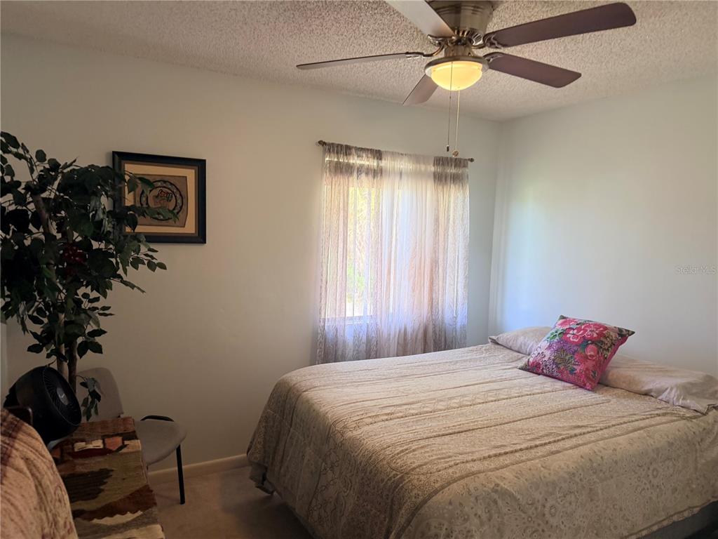 2615 Willow Oak Drive Edgewater, FL 32141 - Photo 37 of 64 a bedroom with a bed and a potted plant