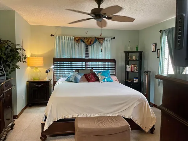 a bedroom with a bed and a chandelier