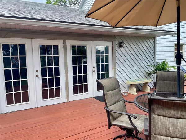 a view of a chair and table in the roof deck