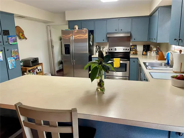 a kitchen with refrigerator and window