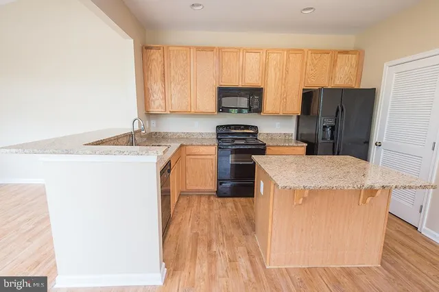 an empty room with wooden floor and a window