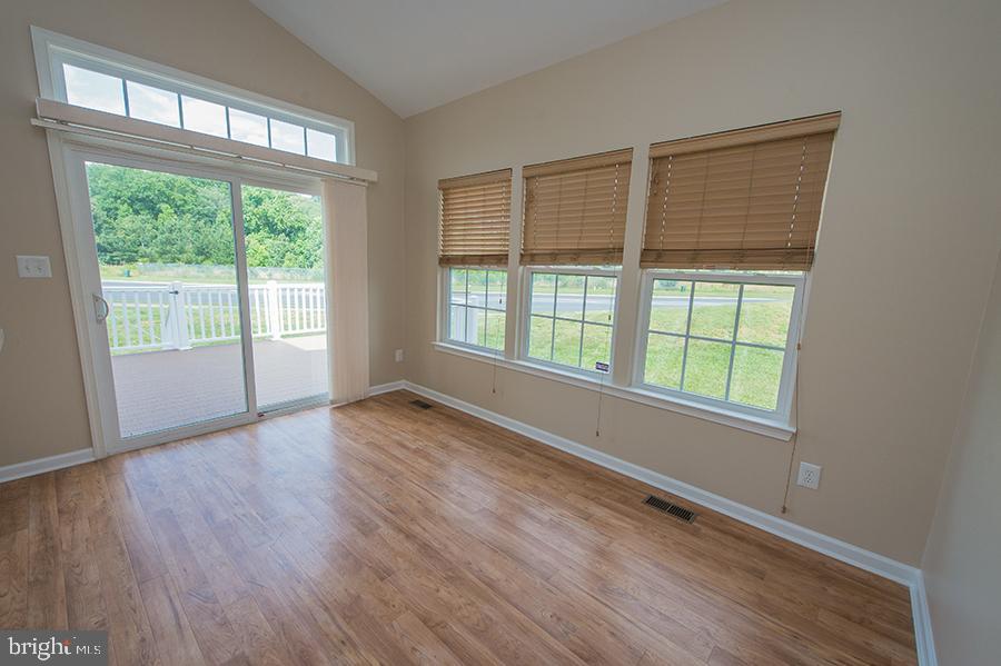 1406 Cat Tail Court Salisbury, MD 21804 - Photo 15 of 68 an empty room with wooden floor and windows