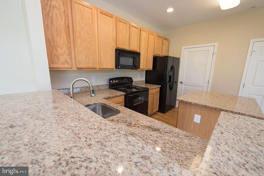 1406 Cat Tail Court Salisbury, MD 21804 - Photo 18 of 68 a kitchen with stainless steel appliances granite countertop a refrigerator stove top oven a sink and dishwasher