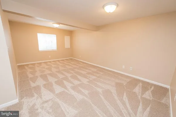 a view of staircase with railing and a rug