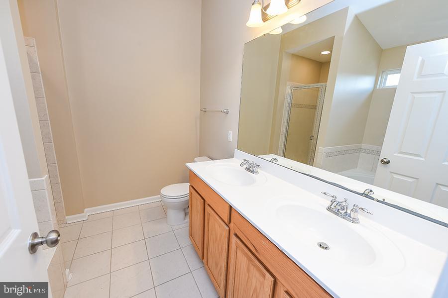 1406 Cat Tail Court Salisbury, MD 21804 - Photo 36 of 68 a bathroom with a sink a toilet and a mirror