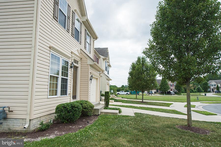 1406 Cat Tail Court Salisbury, MD 21804 - Photo 4 of 68 a view of a white house in a big yard with large trees