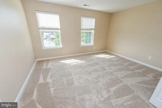 a view of backyard with deck and large window