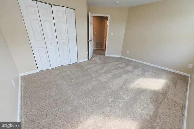 a view of a house with a big yard and large trees