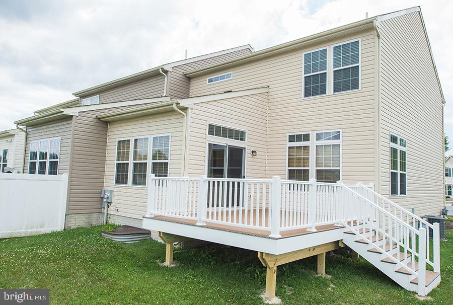 1406 Cat Tail Court Salisbury, MD 21804 - Photo 59 of 68 a white house that has a small deck and a yard with wooden fence