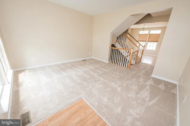 a view of staircase with white walls and windows