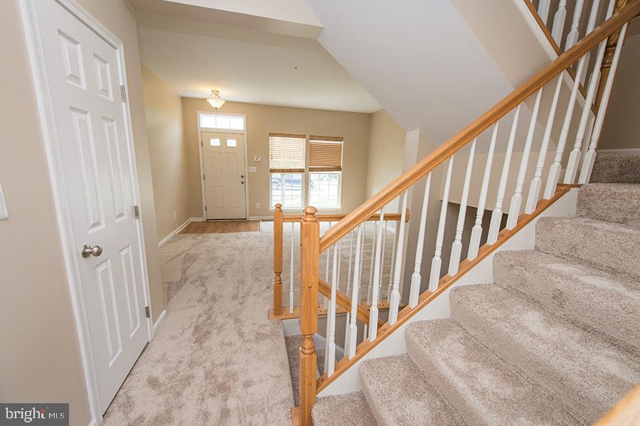 1406 Cat Tail Court Salisbury, MD 21804 - Photo 9 of 68 a view of staircase with lots of frames on wall and a window