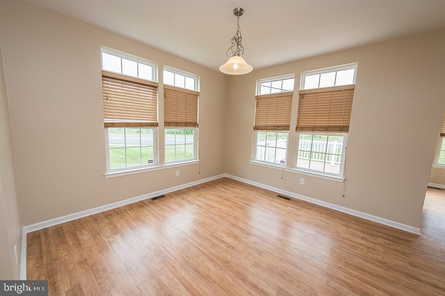 1406 Cat Tail Court Salisbury, MD 21804 - Photo 10 of 68 a view of an empty room with wooden floor and a window