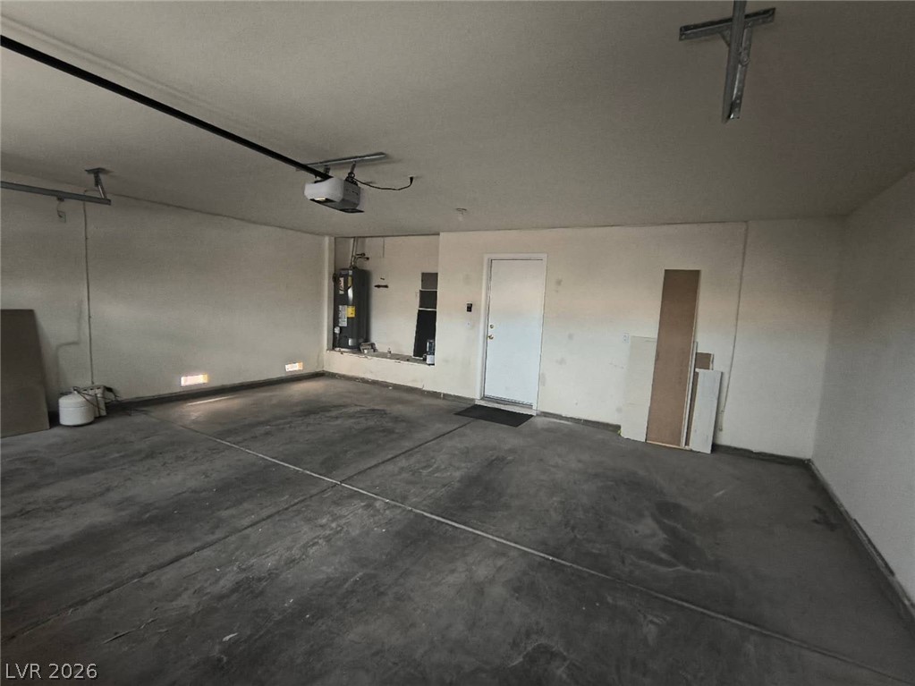 9725 Pima Point Avenue Las Vegas, NV 89147 - Photo 34 of 35 A spacious and functional garage provides ample parking and utility access.