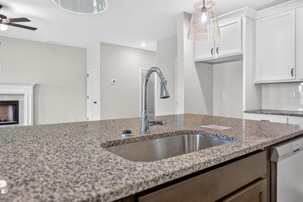 6 Liberty Place Fort Mitchell, AL 36856 - Photo 12 of 27 a kitchen with granite countertop a sink and a stove top oven