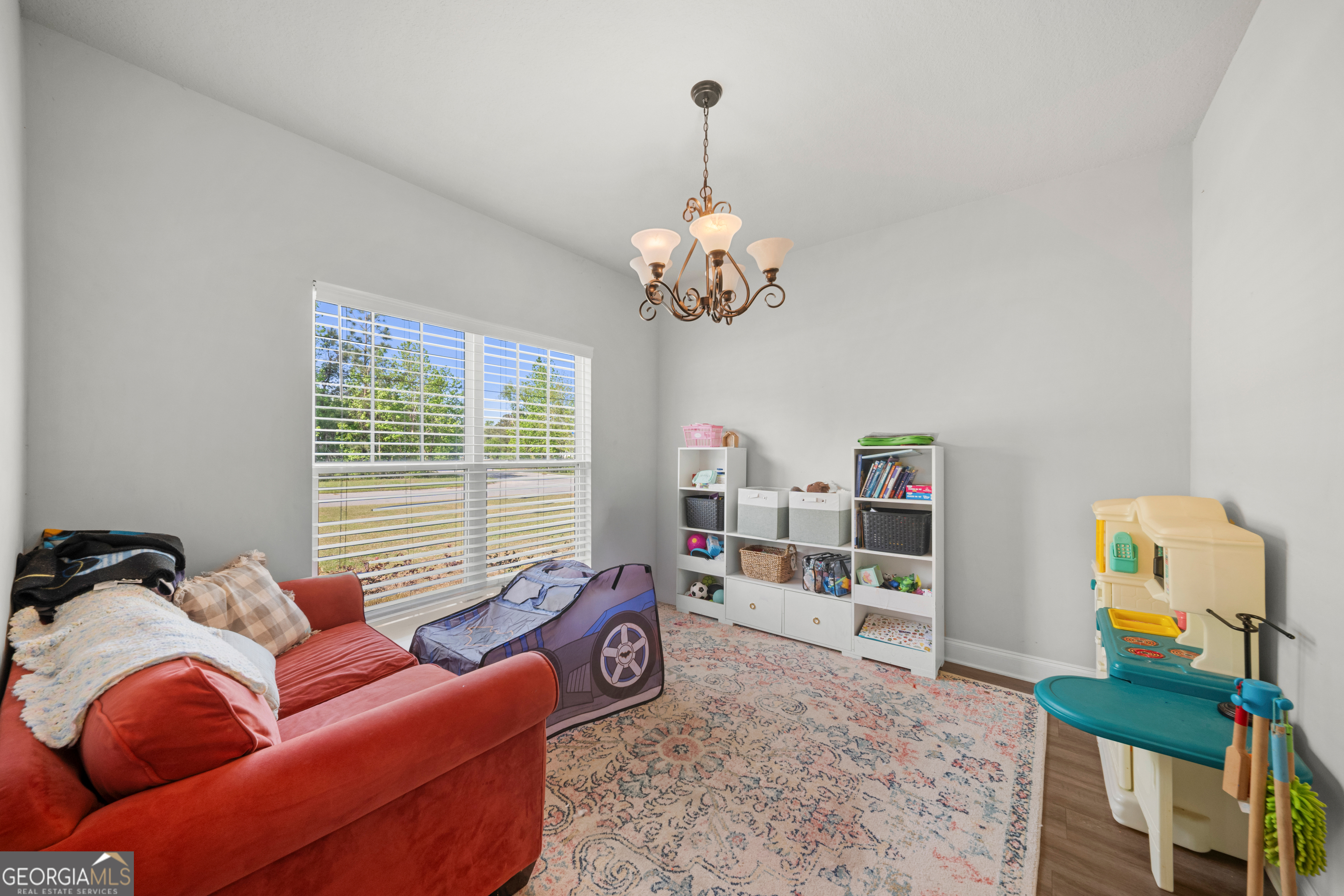 401 Elwick Place Statesboro, GA 30461 - Photo 11 of 36 a bedroom with furniture and a chandelier