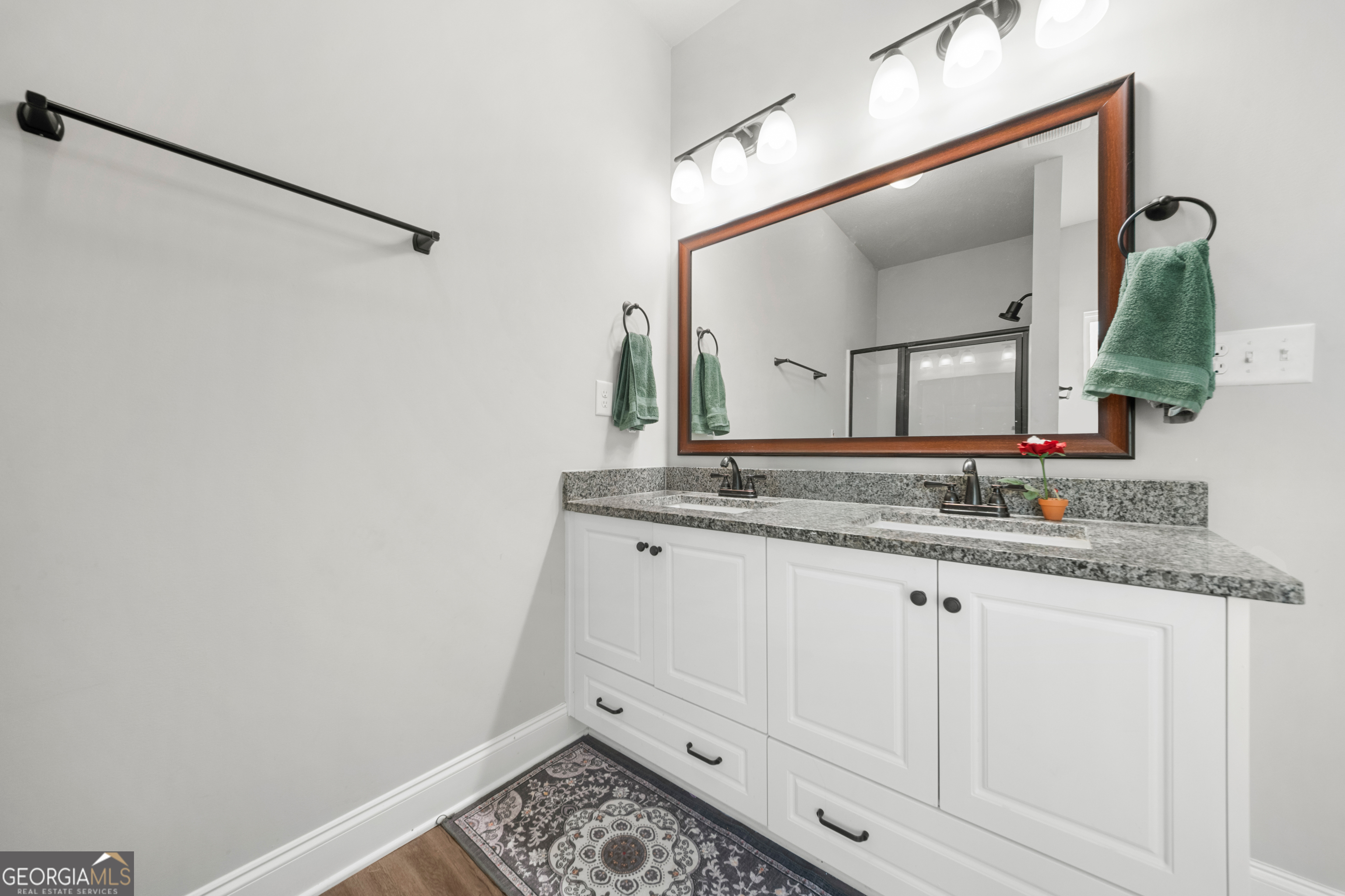 401 Elwick Place Statesboro, GA 30461 - Photo 21 of 36 a bathroom with a granite countertop sink and a mirror
