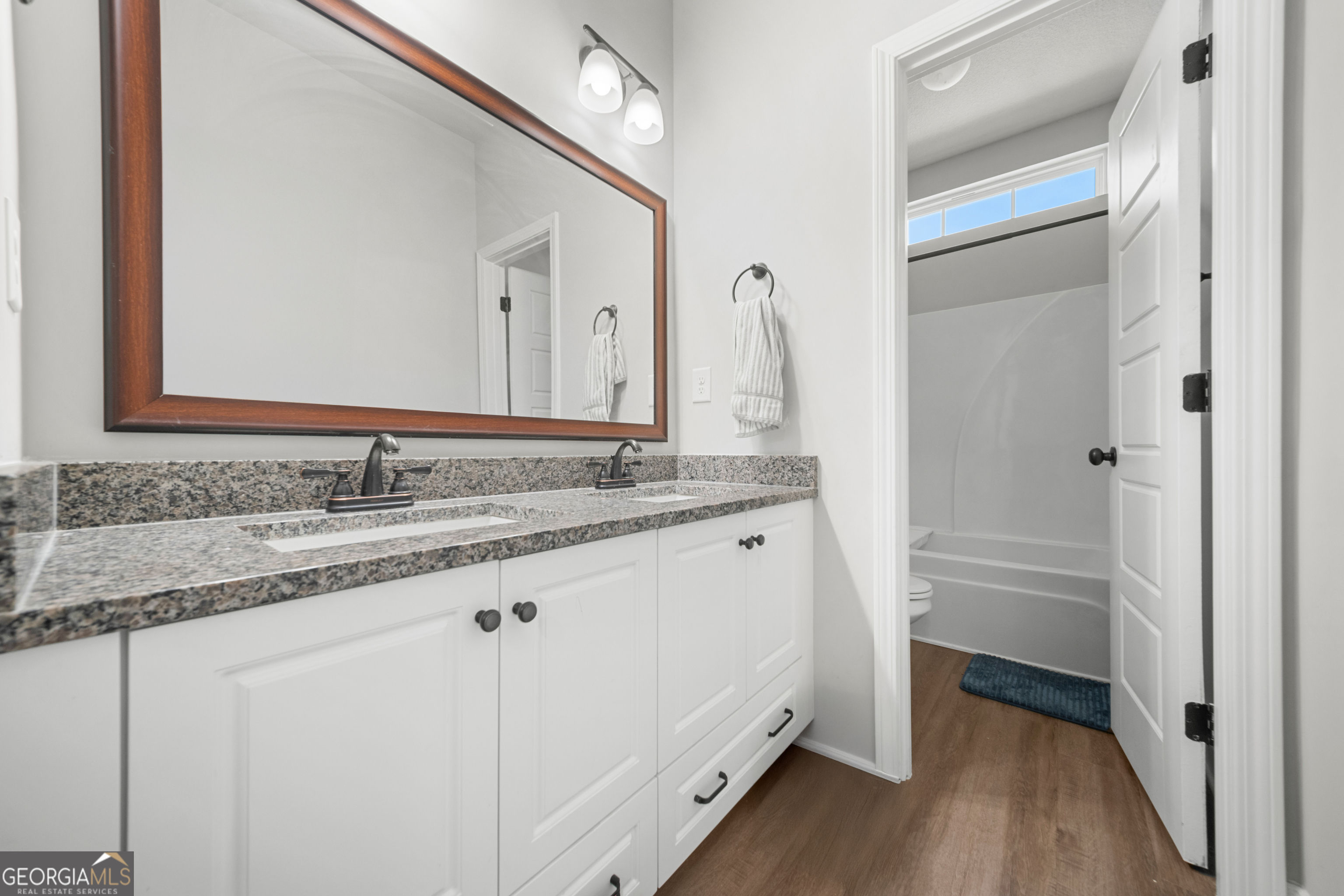 401 Elwick Place Statesboro, GA 30461 - Photo 25 of 36 a bathroom with a granite countertop sink and a mirror