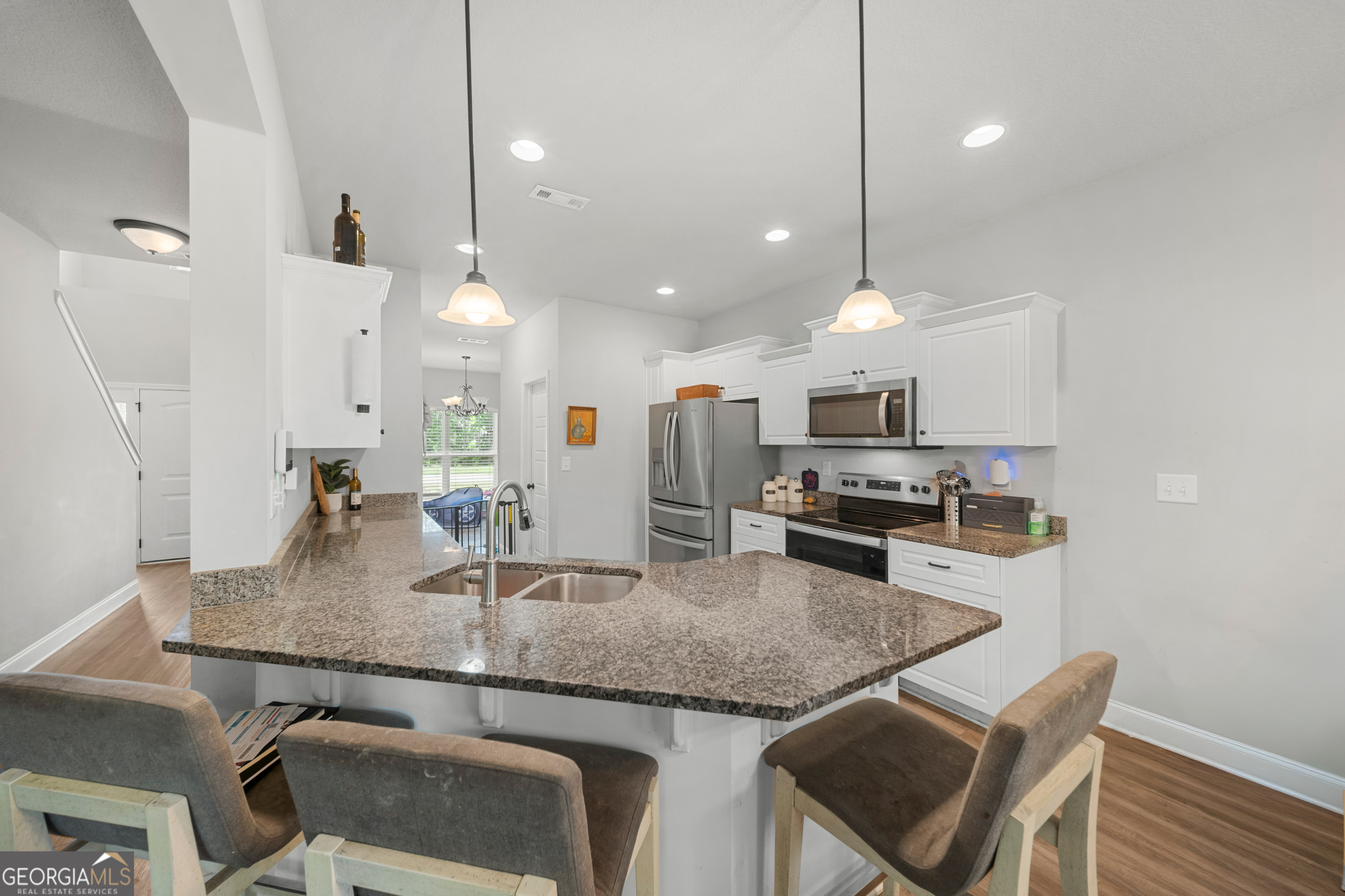 401 Elwick Place Statesboro, GA 30461 - Photo 7 of 36 a kitchen with granite countertop kitchen island stainless steel appliances a sink and a center island