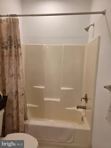 a bathroom with a shower and a toilet