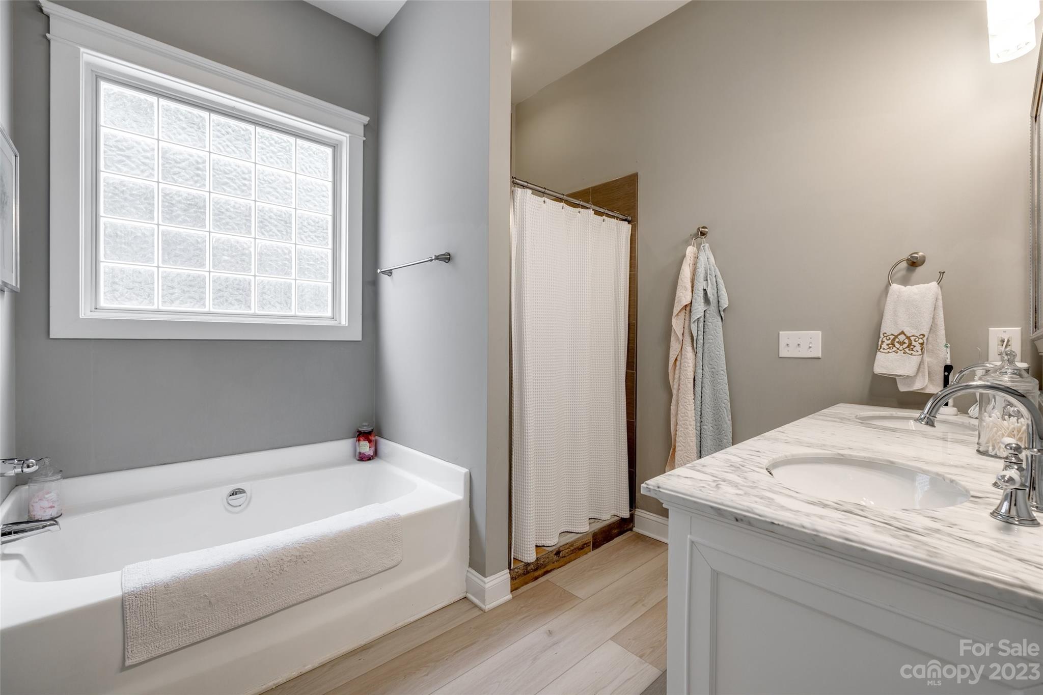 3292 Richard's Crossing Fort Mill, SC 29708 - Photo 21 of 39 a bathroom with a tub sink and a mirror