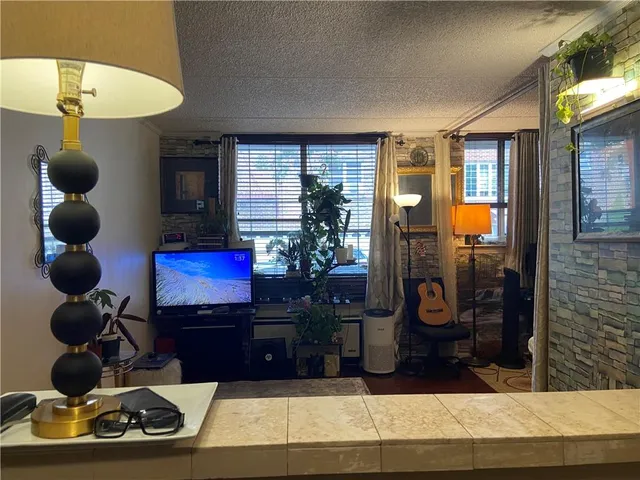 a living room with furniture and a mirror