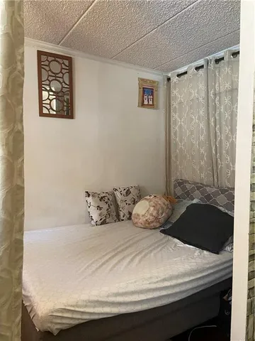 a bedroom with a bed and a wall painting