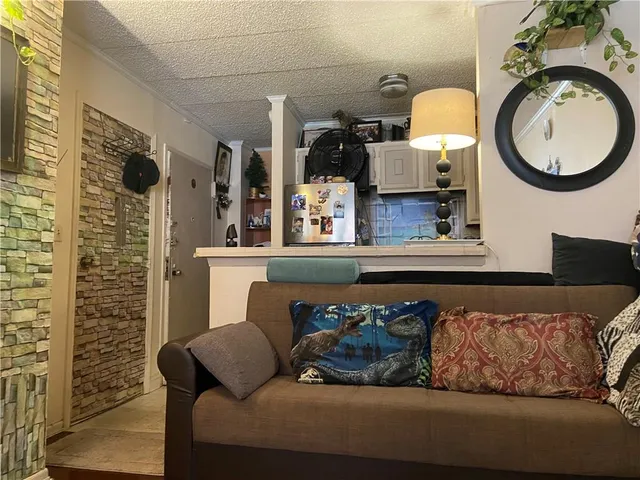 a living room with furniture and a mirror