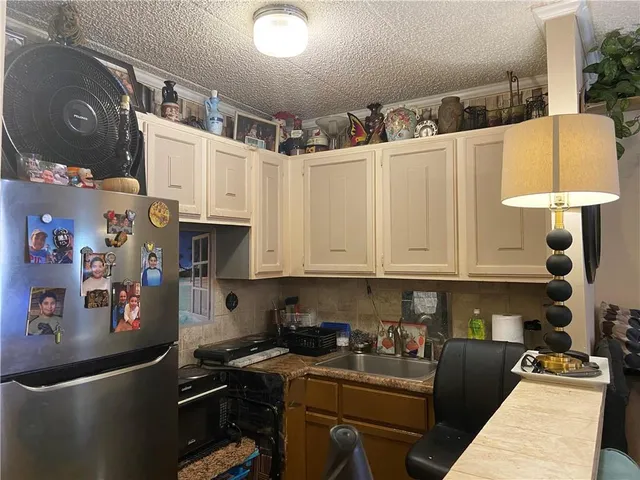 a kitchen with stainless steel appliances granite countertop a stove a sink and cabinets