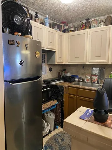 a kitchen with a refrigerator and cabinets