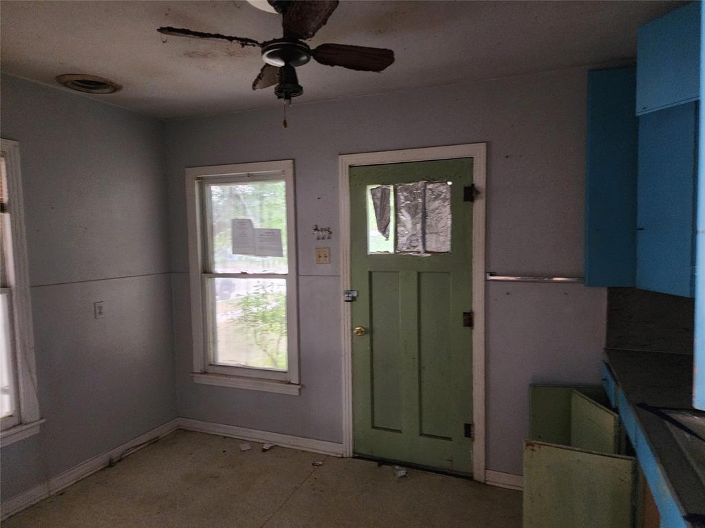 407 Largent Avenue Ballinger, TX 76821 - Photo 8 of 17 Kitchen entrance featuring a ceiling fan and baseboards - Left Side