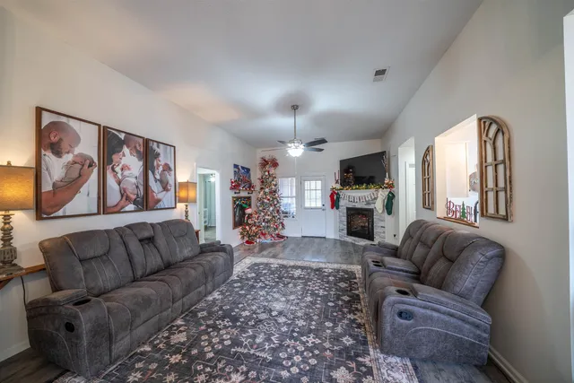 a living room with furniture and a fireplace