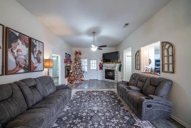 a living room with furniture and a chandelier